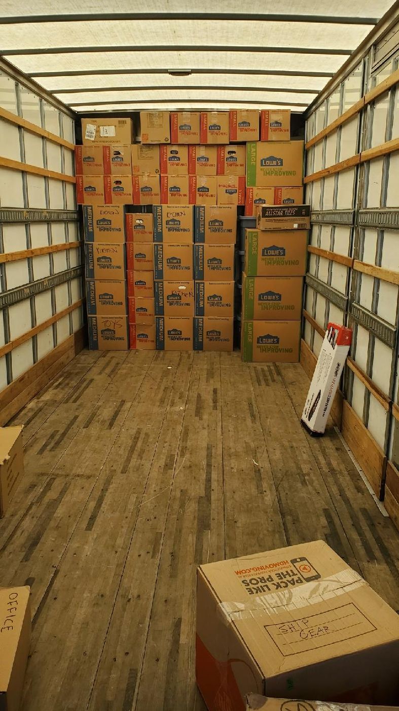 Box truck packed floor to ceiling with neatly stacked boxes